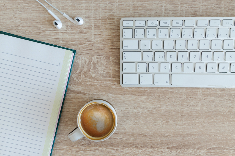 Business workspace with keyboard and headphones representing AI call handling